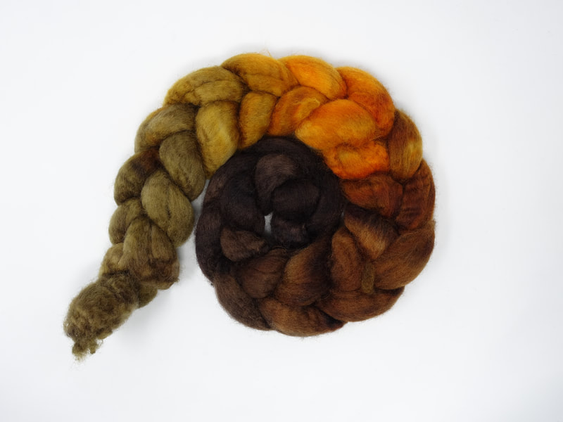 Spiral of braided fibre. Colour transition- chestnut, sienna, orange, brown