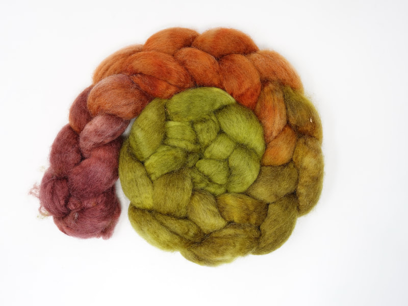 Spiral of braided fibre. Colour transition- olive, mustard, orange, rouge. 