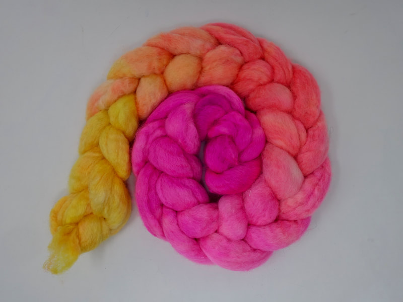 Spiral of braided fibre. Colour transition- fluorescent pink, salmon, orange, lemon
