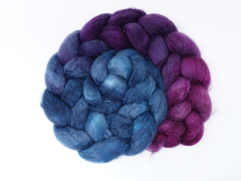 A braid of gradient fibre that transition from mid-aqua blue to dark violet to a pink-tined purple. 