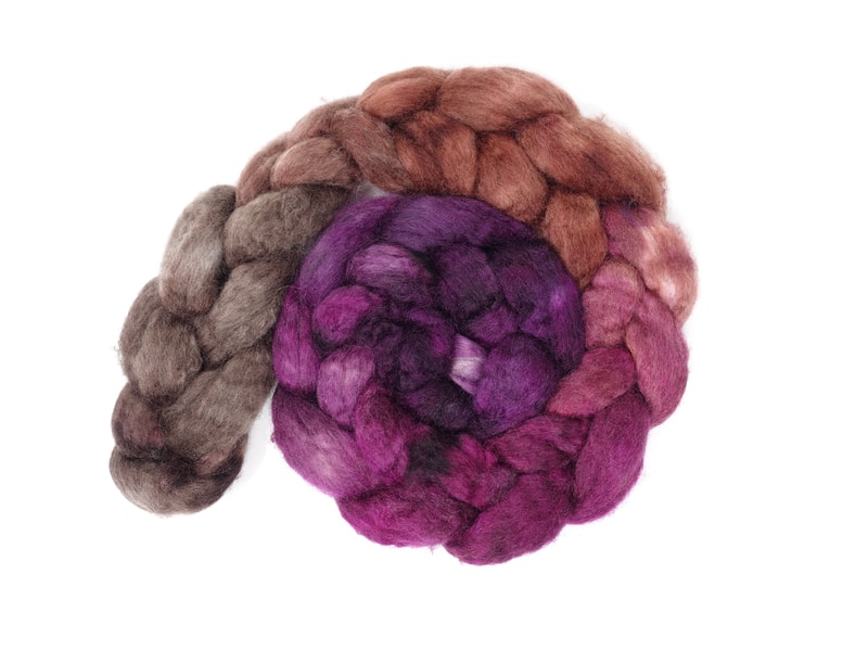 A braid of fibre that transitions from brown to tan, to pink-purple to aubergine