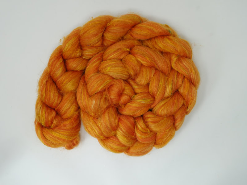 Bright Orange fibre with shine and textural nepps. 