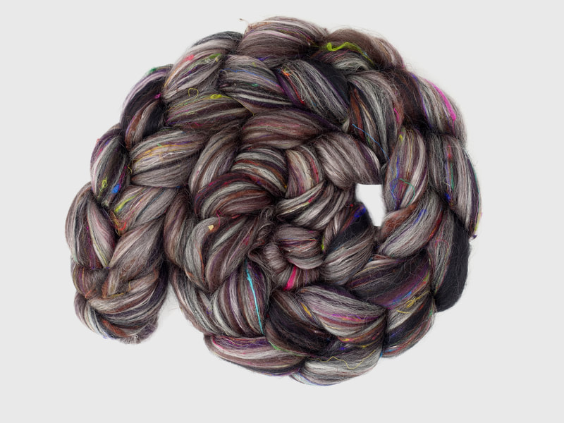Dark brown braid of fibre with streaks of silver-grey and flecks of rainbow colours. 