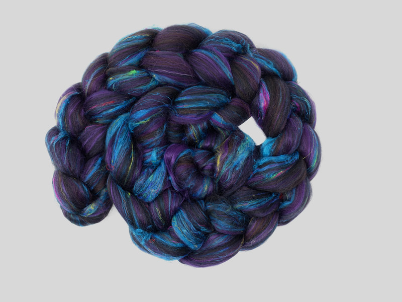 Dark Purple fibre with hints of black, and turquoise blue texture.