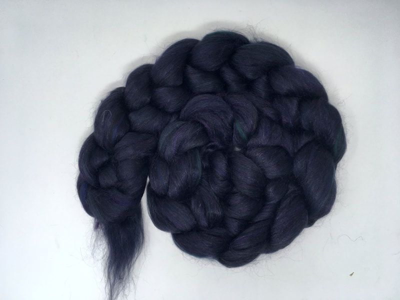 A spiral of beaded dark black fibre